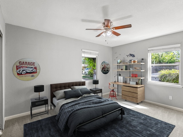bedroom with multiple windows, carpet floors, and baseboards