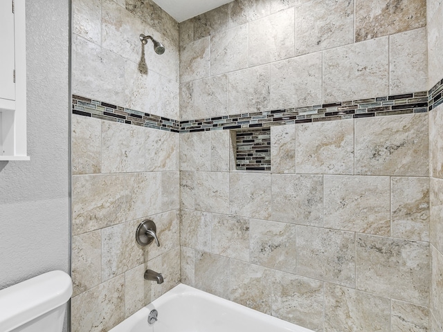 full bathroom with toilet and washtub / shower combination