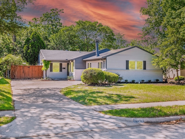 ranch-style home with concrete driveway and brick siding
