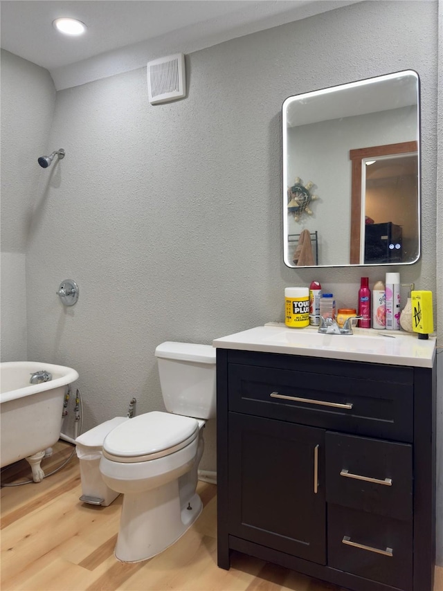 157 Business Blvd, Granbury, TX 76049 - bathroom with vanity, toilet, wood finished floors, and a freestanding bath