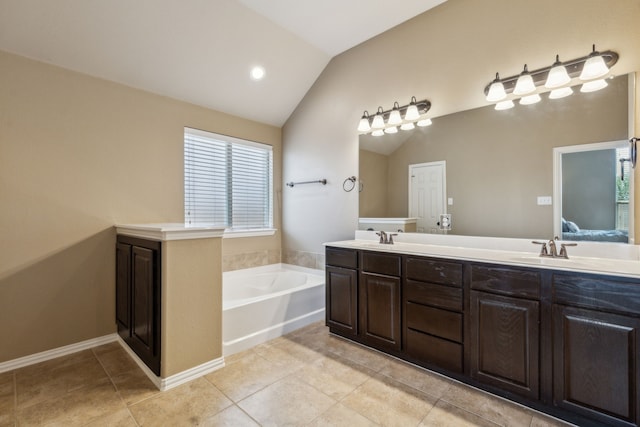 ensuite bathroom with double vanity, lofted ceiling, a garden tub, and a sink