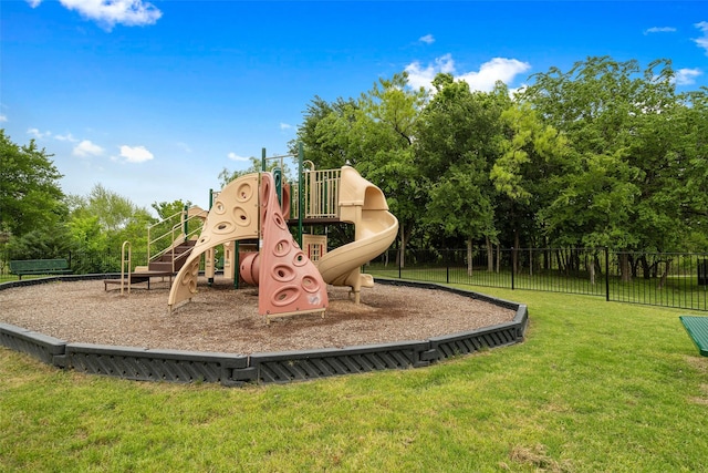 community playground featuring fence and a yard