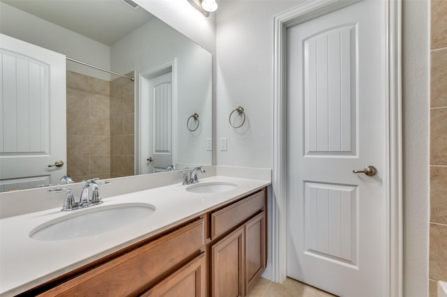 bathroom with tile patterned floors, a sink, and double vanity