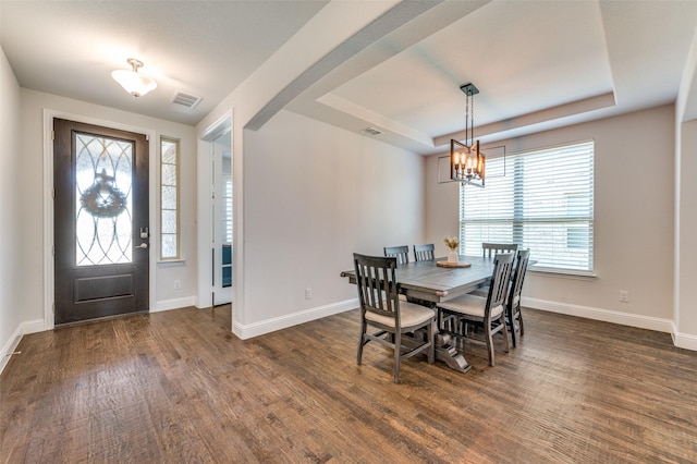 dining area with a chandelier, plenty of natural light, visible vents, and dark wood-style flooring