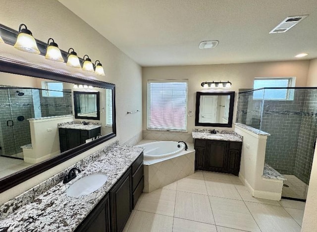 1005 Walford Dr, Forney, TX 75126 - bathroom featuring a shower stall, a bath, two vanities, and tile patterned flooring