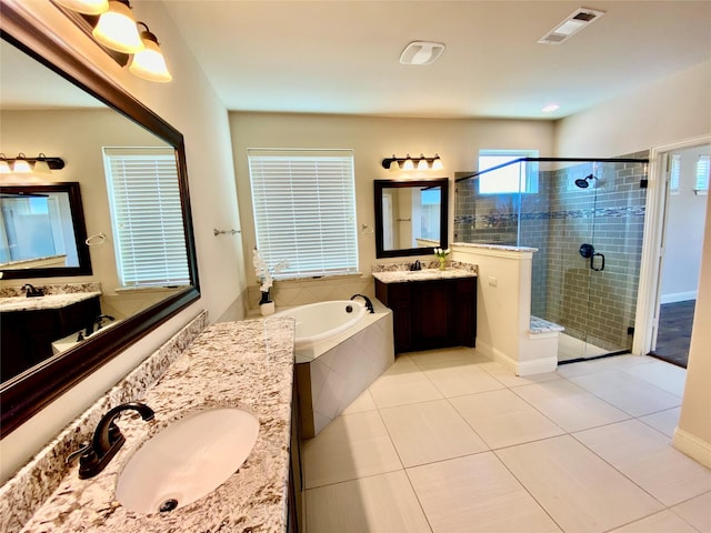 1005 Walford Dr, Forney, TX 75126 - bathroom with a stall shower, two vanities, a bath, and tile patterned floors