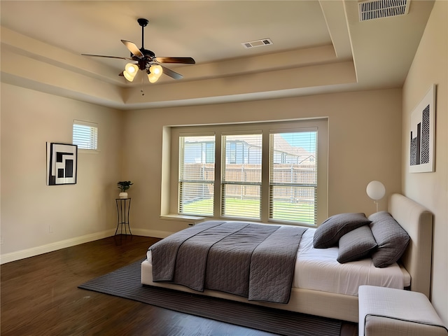 1005 Walford Dr, Forney, TX 75126 - bedroom with a tray ceiling, baseboards, wood finished floors, and a ceiling fan