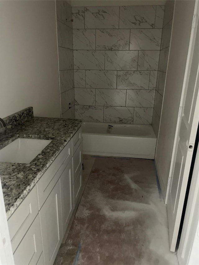 2510 Oxford Ave, Fort Worth, TX 76106 - bathroom featuring vanity, washtub / shower combination, and concrete flooring
