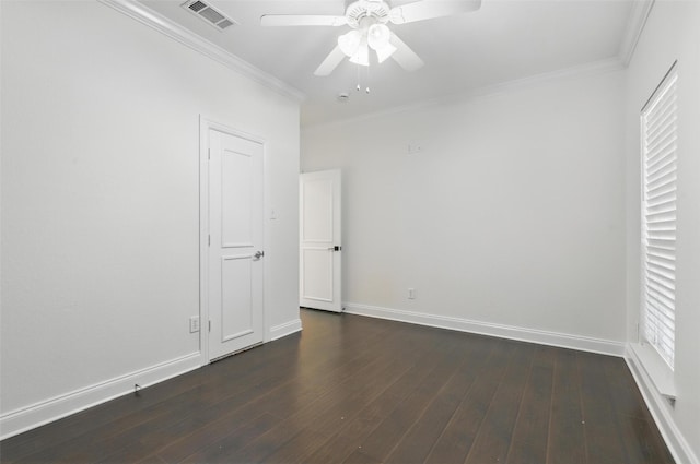 unfurnished bedroom with dark wood-style floors, baseboards, crown molding, and visible vents