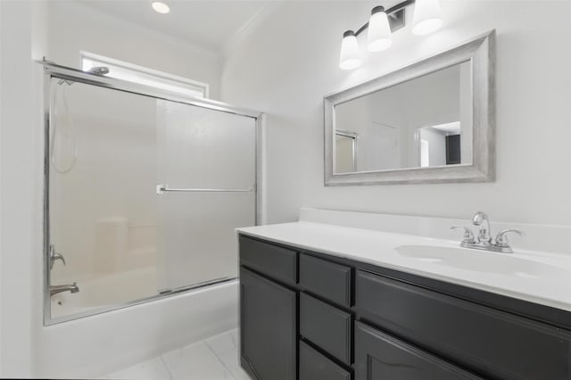 full bathroom featuring shower / bath combination with glass door, crown molding, and vanity