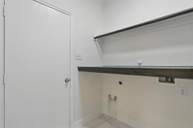 laundry room with electric dryer hookup, marble finish floor, baseboards, laundry area, and washer hookup
