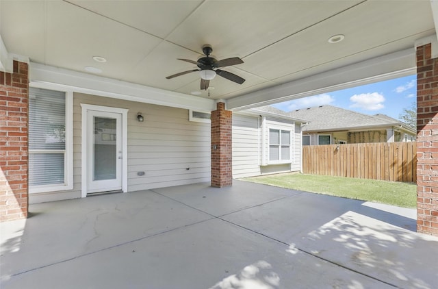 view of patio with a ceiling fan and fence