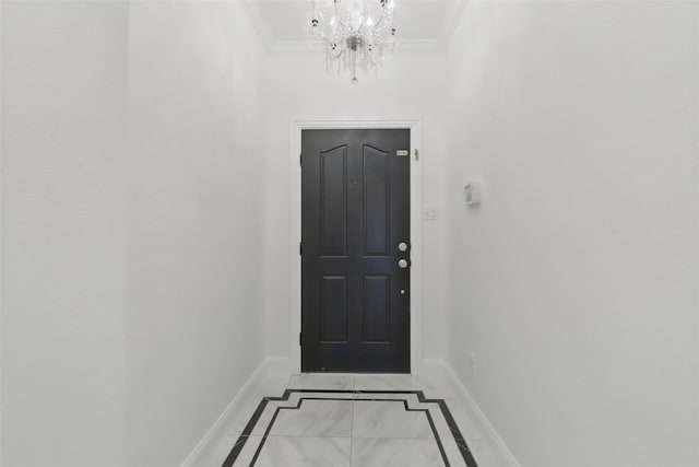 doorway featuring a notable chandelier, baseboards, and ornamental molding
