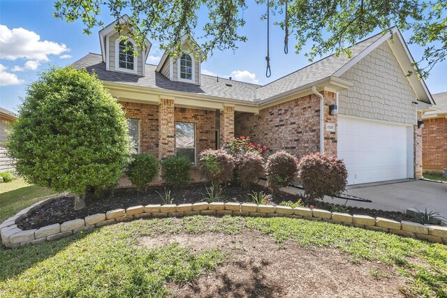 view of front of house featuring brick siding, a shingled roof, a garage, and concrete driveway