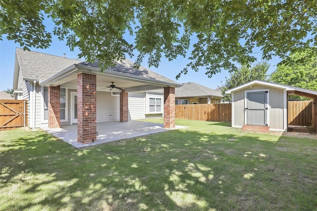 view of yard featuring a fenced backyard, a ceiling fan, a patio, and a storage shed