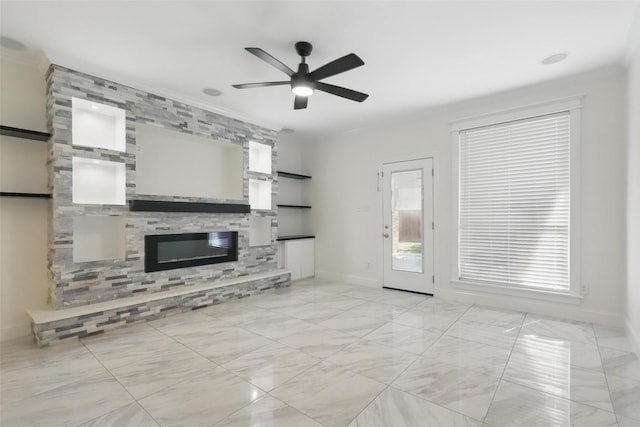 unfurnished living room with marble finish floor, baseboards, a ceiling fan, and a large fireplace