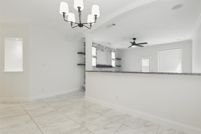interior space featuring ceiling fan with notable chandelier, baseboards, visible vents, and crown molding