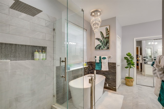 full bathroom featuring a chandelier, walk in shower, and a freestanding tub