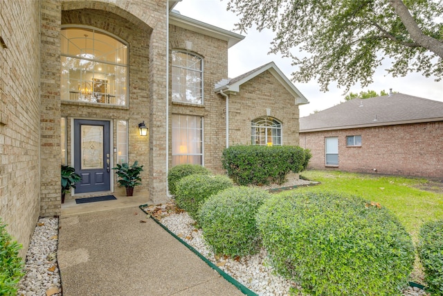 doorway to property featuring brick siding