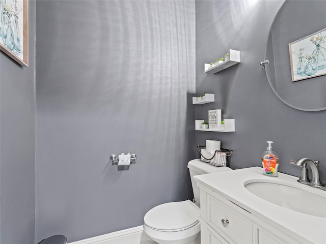 half bath featuring toilet and vanity