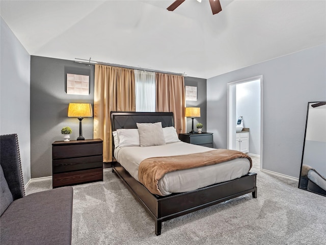 bedroom with carpet floors, baseboards, connected bathroom, and a ceiling fan