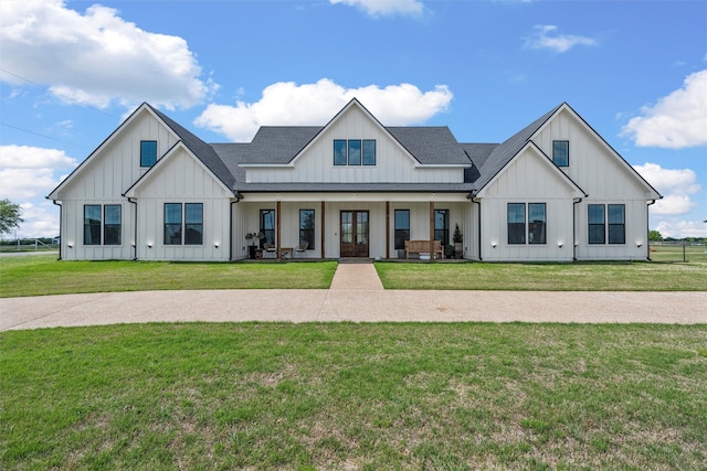 modern farmhouse style home with a front lawn, roof with shingles, board and batten siding, and french doors