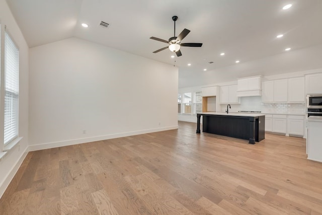 636 Caprice Blf, Fate, TX 75189 - unfurnished living room with recessed lighting, light wood finished floors, vaulted ceiling, visible vents, and a ceiling fan