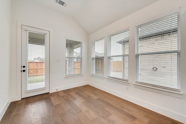 636 Caprice Blf, Fate, TX 75189 - unfurnished sunroom with lofted ceiling, wood finished floors, visible vents, and baseboards