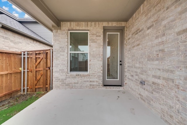 636 Caprice Blf, Fate, TX 75189 - entrance to property featuring a gate, fence, a patio area, and brick siding