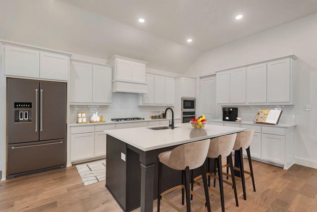 636 Caprice Blf, Fate, TX 75189 - kitchen with light countertops, a sink, appliances with stainless steel finishes, and a kitchen breakfast bar