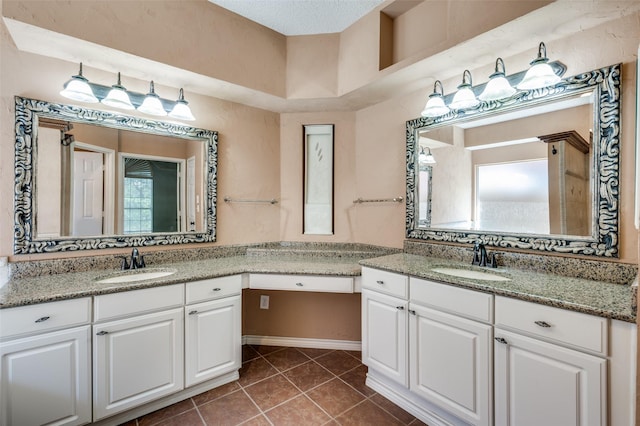 bathroom with tile patterned flooring and two vanities