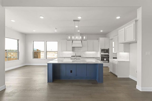 kitchen featuring white cabinets, baseboards, appliances with stainless steel finishes, and dark wood-type flooring