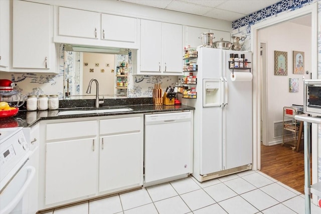 4924 Cobbs Dr Unit 3D, Waco, TX 76710 - kitchen featuring white cabinets, a sink, a drop ceiling, white appliances, and light tile patterned floors