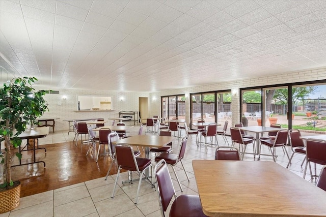 4924 Cobbs Dr Unit 3D, Waco, TX 76710 - dining room with brick wall and light tile patterned floors