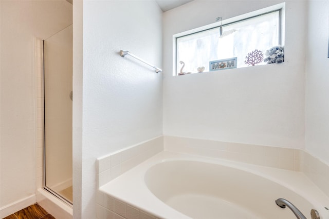 full bathroom with an enclosed shower and a bath