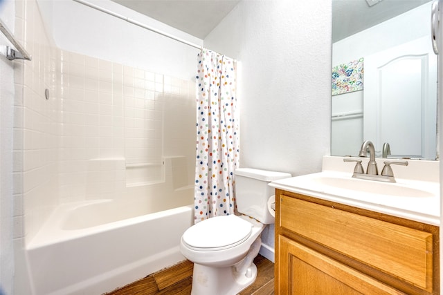 bathroom with shower / bath combo with shower curtain, wood finished floors, toilet, and vanity