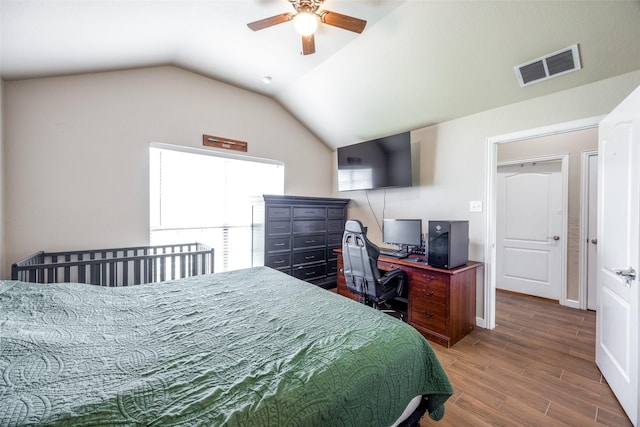 bedroom featuring ceiling fan, lofted ceiling, wood finished floors, and visible vents