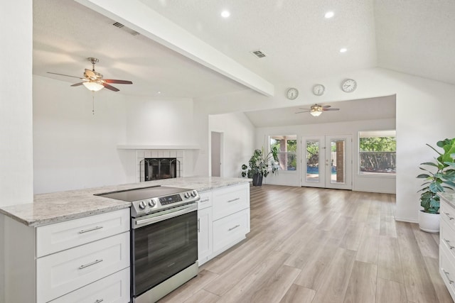 kitchen featuring ceiling fan, open floor plan, and stainless steel electric range