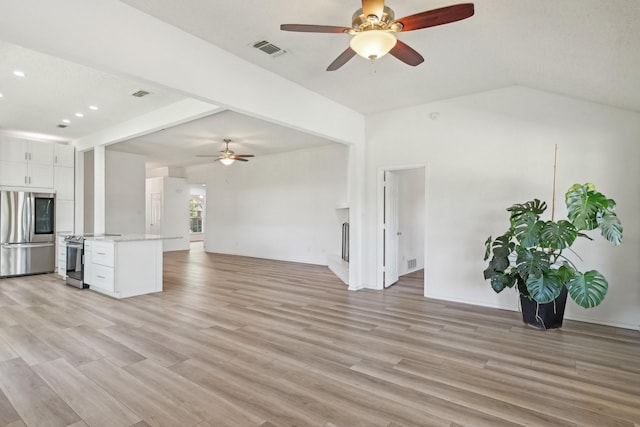 unfurnished living room with a ceiling fan, visible vents, and light wood-style floors
