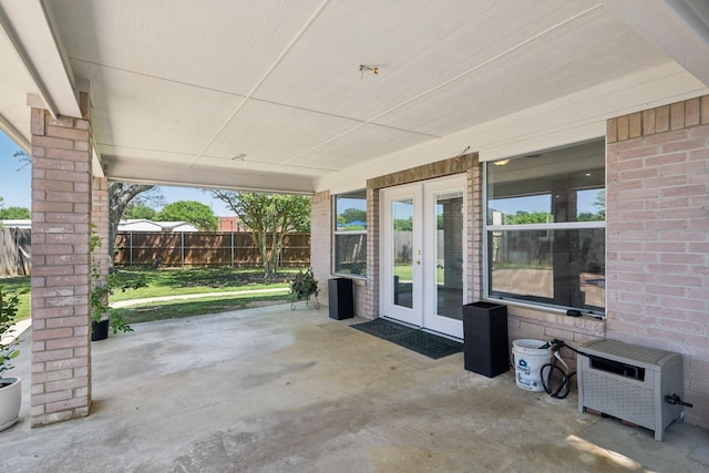 view of patio / terrace featuring fence and french doors