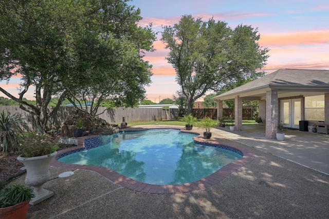 view of pool featuring french doors, a fenced in pool, a fenced backyard, and a patio