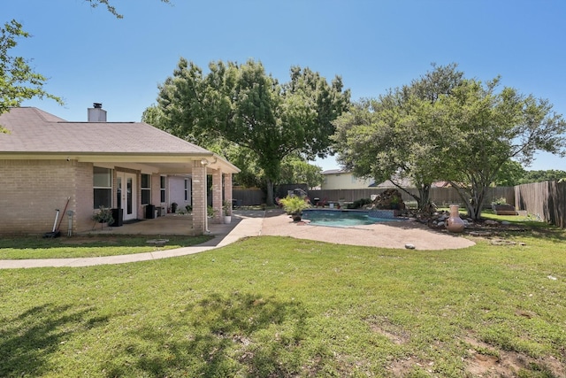 view of yard featuring a fenced backyard, a patio, a fenced in pool, and french doors