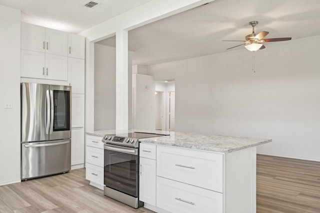 kitchen with light wood finished floors, stainless steel appliances, white cabinetry, ceiling fan, and light stone countertops