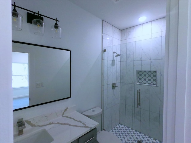 full bath with vanity, toilet, and a stall shower