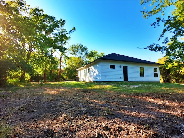 rear view of property featuring central AC