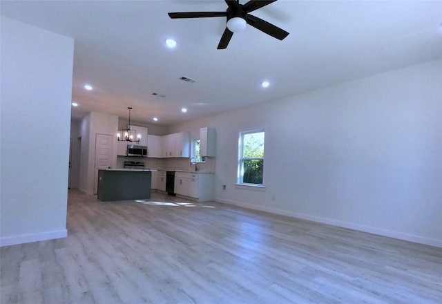 unfurnished living room with recessed lighting, a sink, light wood-style floors, baseboards, and ceiling fan with notable chandelier