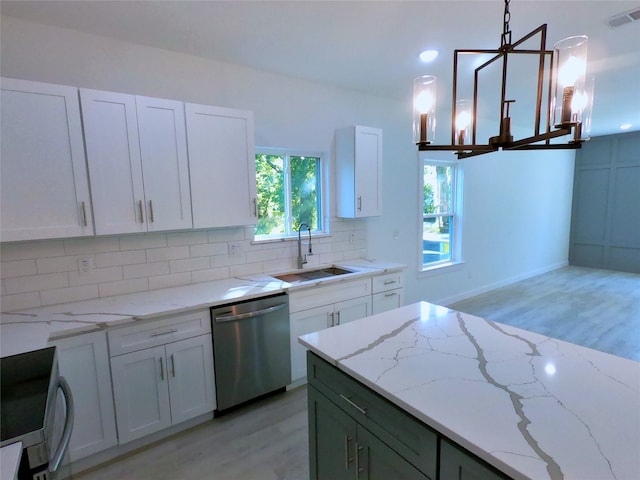 kitchen featuring stainless steel dishwasher, visible vents, a sink, and light wood-style flooring