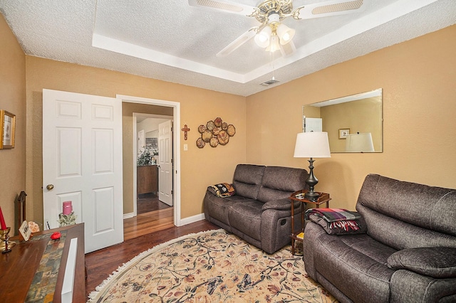 5625 Guadalajara Dr, North Richland Hills, TX 76180 - living area featuring ceiling fan, wood finished floors, baseboards, a textured ceiling, and a tray ceiling