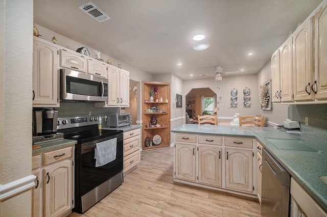 5625 Guadalajara Dr, North Richland Hills, TX 76180 - kitchen with appliances with stainless steel finishes, a peninsula, light wood-style flooring, recessed lighting, and open shelves