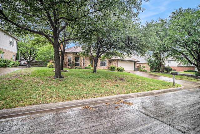 5625 Guadalajara Dr, North Richland Hills, TX 76180 - view of front of home with concrete driveway, an attached garage, a front lawn, and brick siding